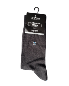 The image shows a pair of dark grey men's socks from the Bolero brand, Exclusive Series, size 43–46. The packaging is black and includes a hanging hook. Near the top of the sock is a small geometric detail – a pattern made of four small squares in white, 