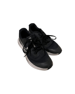 The image shows a pair of Nike running shoes. The shoes are dark blue and made of mesh material with synthetic reinforcements around the laces and sides of the foot. They have black laces and white rubber soles. A white Nike "swoosh" logo is visible on th